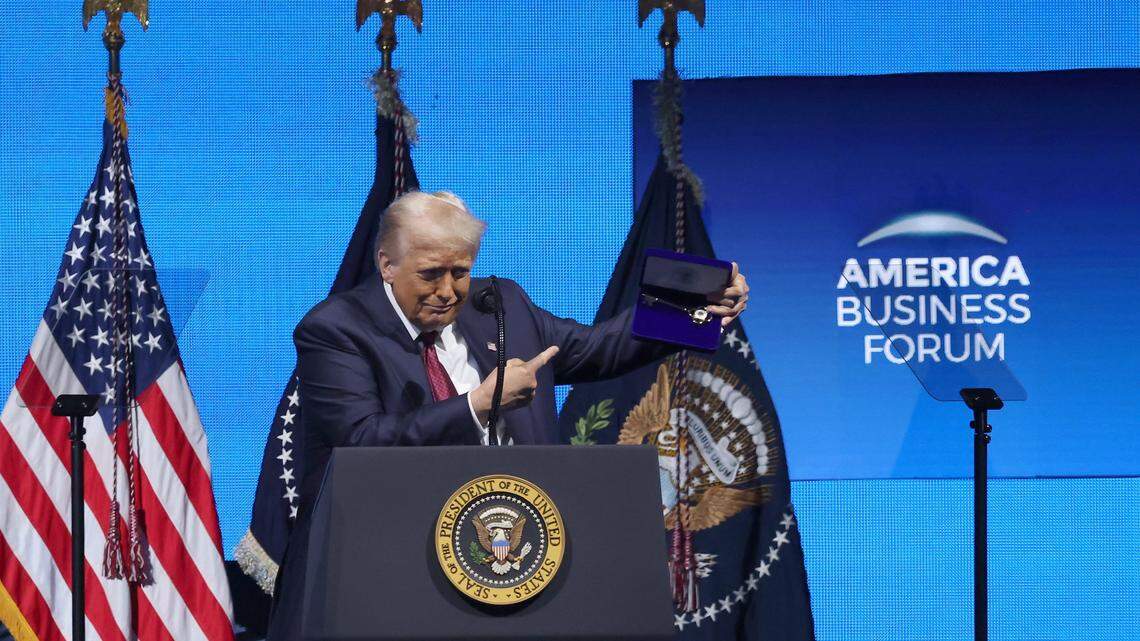 President Donald J. Trump points to the “Key-to-the-City” given to him by Mayor Suarez as he prepares to leave the stage during American Business Forum at the Kaseya Center in Miami, Florida on Wednesday, November 5, 2025.