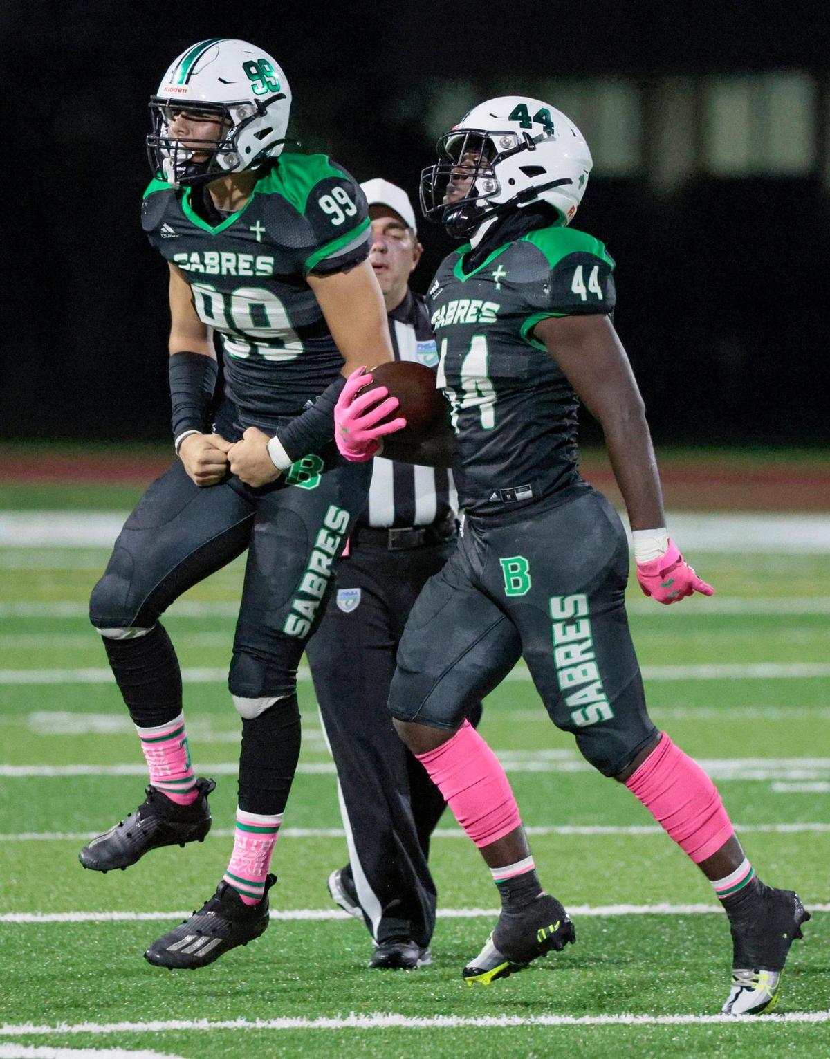 St Brendan’s linebacker Anthony Gray (44) celebrates with defensive end Pablo Pena (99) after Gray recovers a fumble by Westland Hialeah in the first quarter at St. Brendan High School on Friday, October 14, 2022.