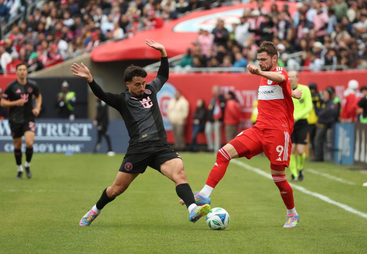 Apr 13, 2025; Chicago, Illinois, USA; Chicago Fire FC forward Hugo Cuypers (9) and Inter Miami CF defender Gonzalo Lujn (2) battle for control of the ball during the second half at Soldier Field. Mandatory Credit: Talia Sprague-Imagn Images