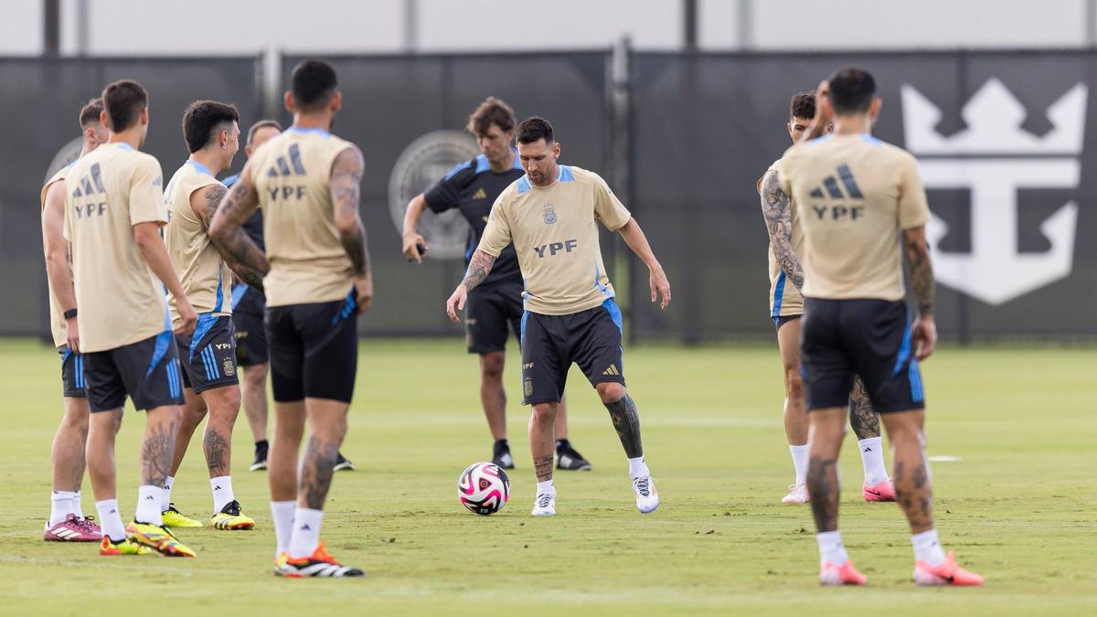 Argentina’s forward Lionel Messi, center, runs drills with his teammates.