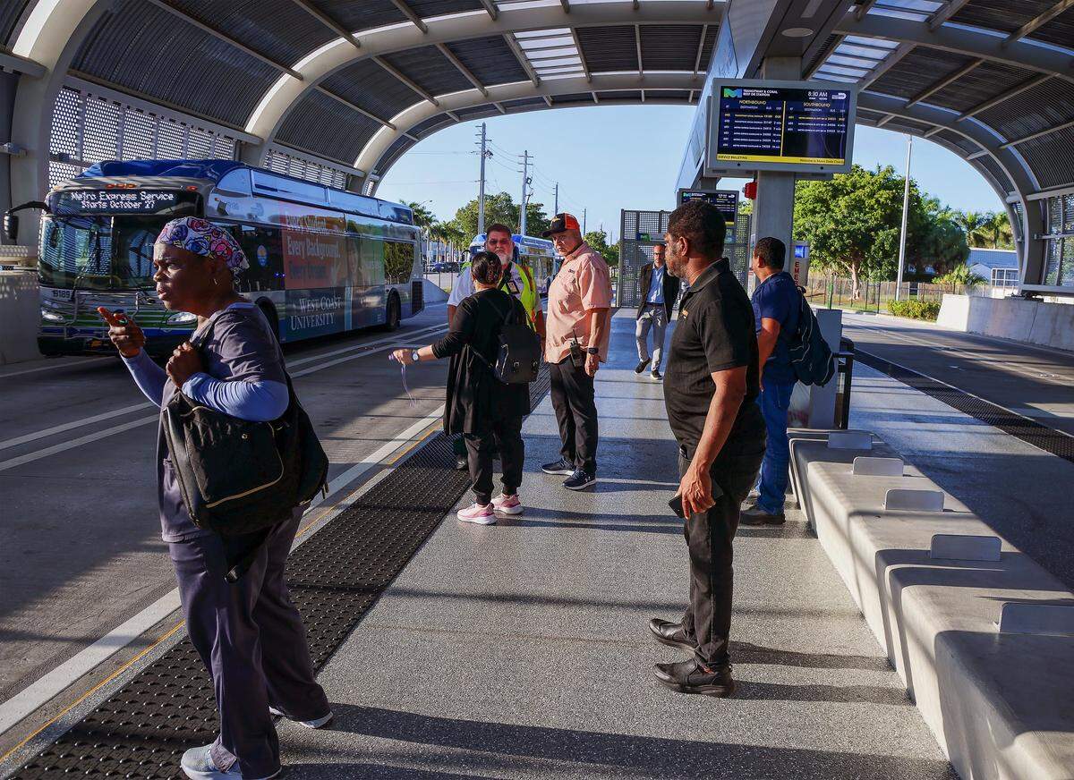 Express bus commuters watch with dismay as local buses arrive at the 152 Street bus stop while passing the 152 Street Station on the first day of Miami-Dade's $300 million rapid-transit bus line known as “Metro Express” on Monday, October 27, 2025, just west of Richmond Heights on Coral Reef Drive and U.S. 1. Many first day riders complained about crowded buses and long travel times due to red lights on the express lane.