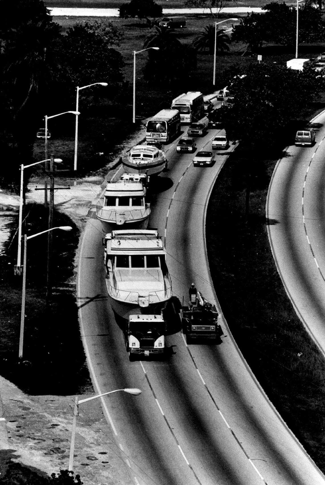 In 1983, yachts travel across the MacArthur Causeway on the way to the boat show at the Miami Beach Convention Center.