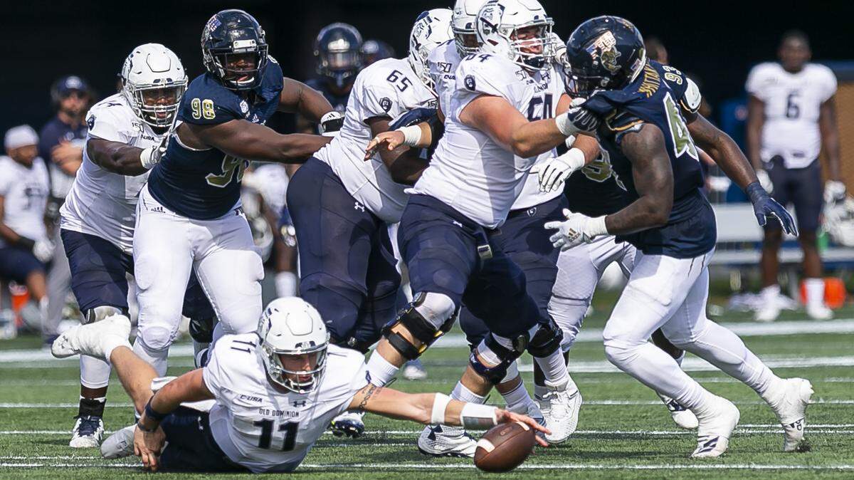 Old Dominion quarterback Hayden Wolff (11) fumbles the ball against the FIU Panthers in the fourth quarter of a football game in the Riccardo Silva Stadium at Florida International University on Saturday, November 2, 2019.