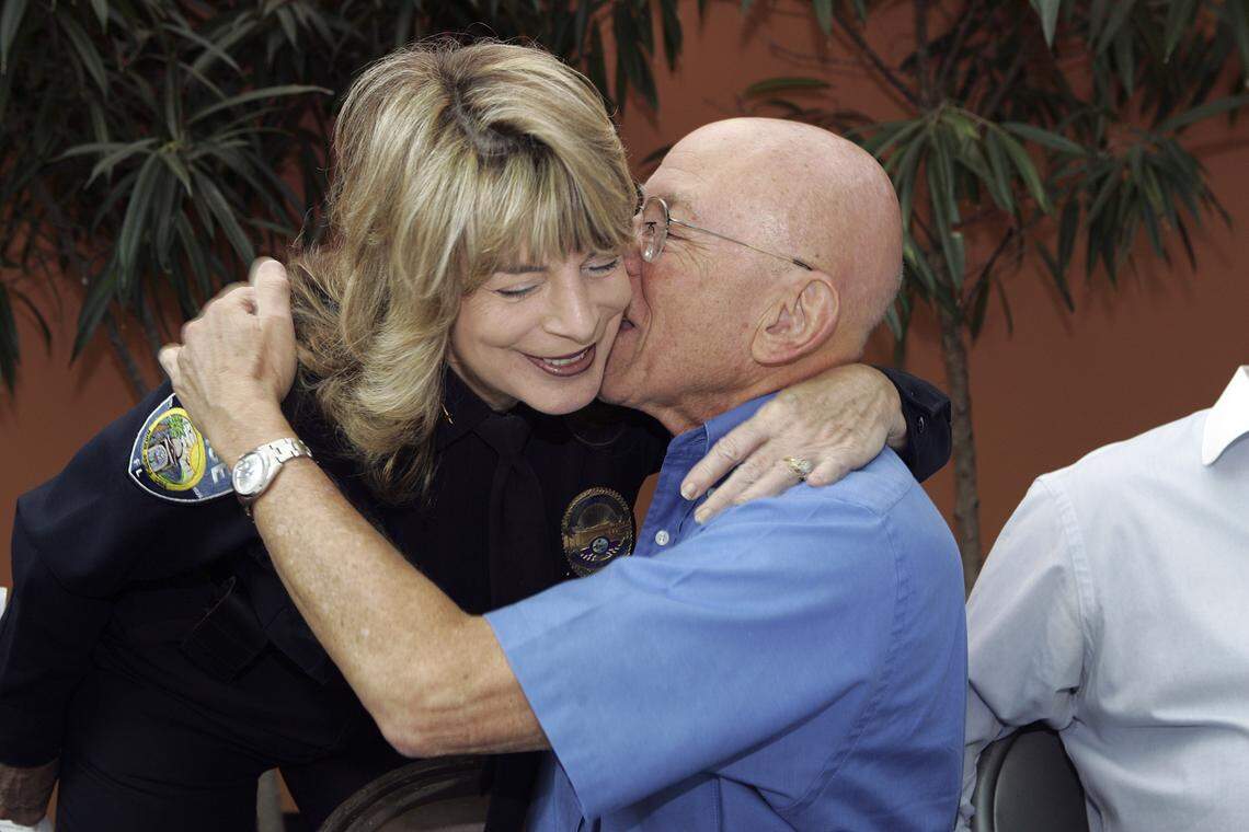 In this Sept. 19, 2007 file photo, North Miami Police Chief Linda Loizzo gets a hug from Dr. Wil Blechman after she announced her retirement from the department after 33 years.