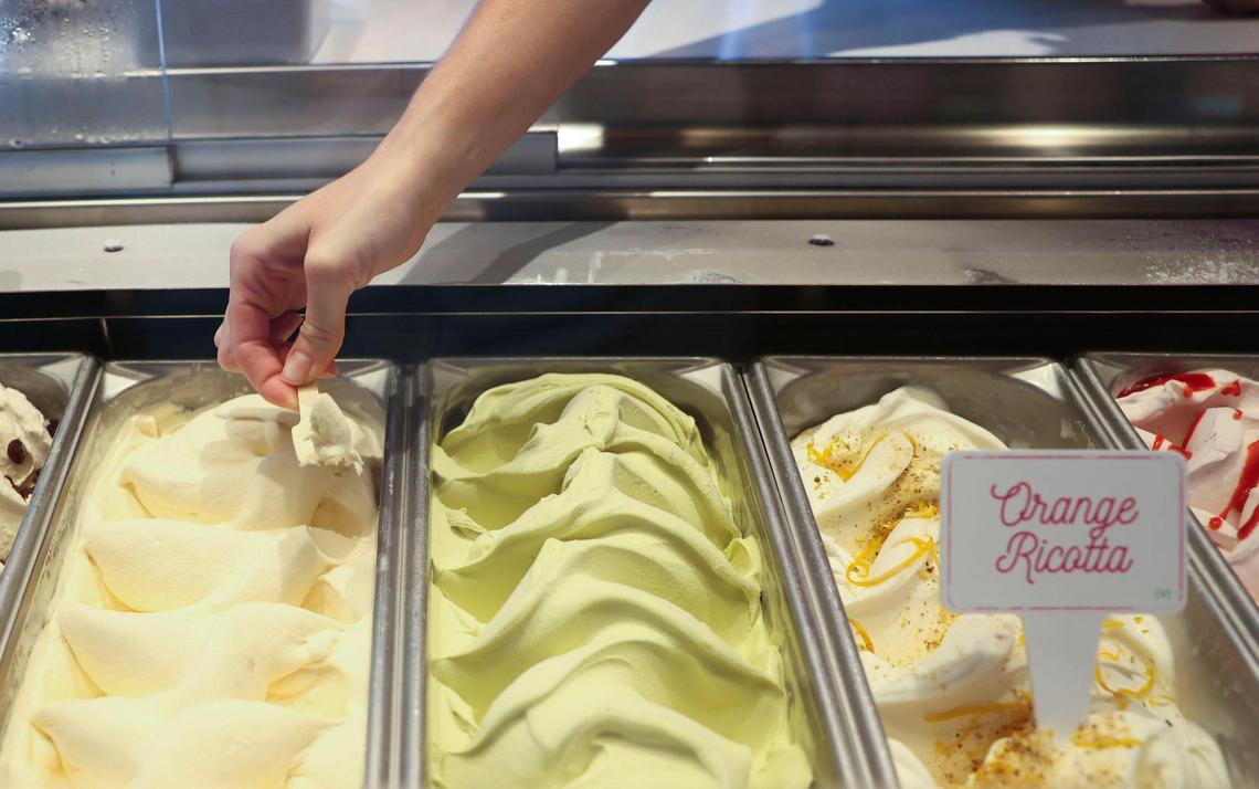 An employee in the ice cream shop on Virgin Voyages’ Valiant Lady gets a sample serving on Sunday, Oct. 30, 2022.