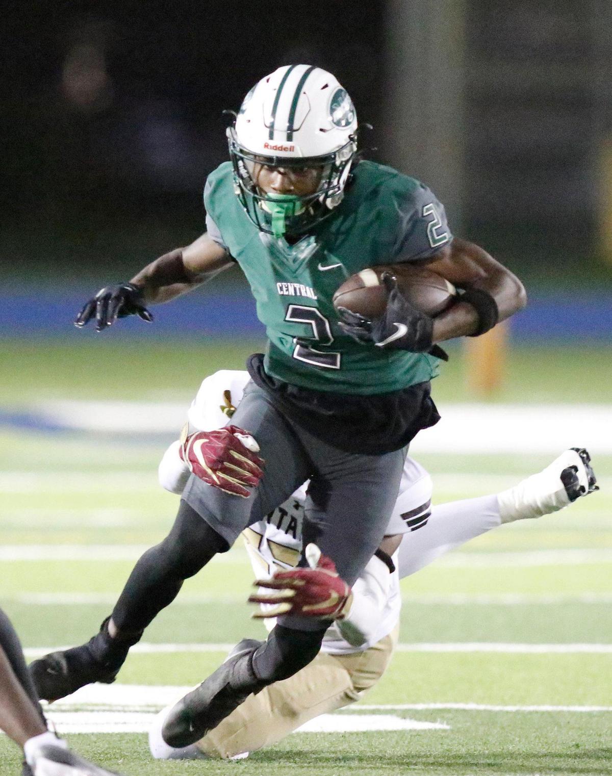 Miami Central Rockets Corey Washington (2) tries to break free from St. Petersburg Lakewood Spartans defender during Class 2M state semifinal game on Friday, December 2, 2022 at Traz Powell Stadium in Miami. Andrew Uloza / for Miami Herald
