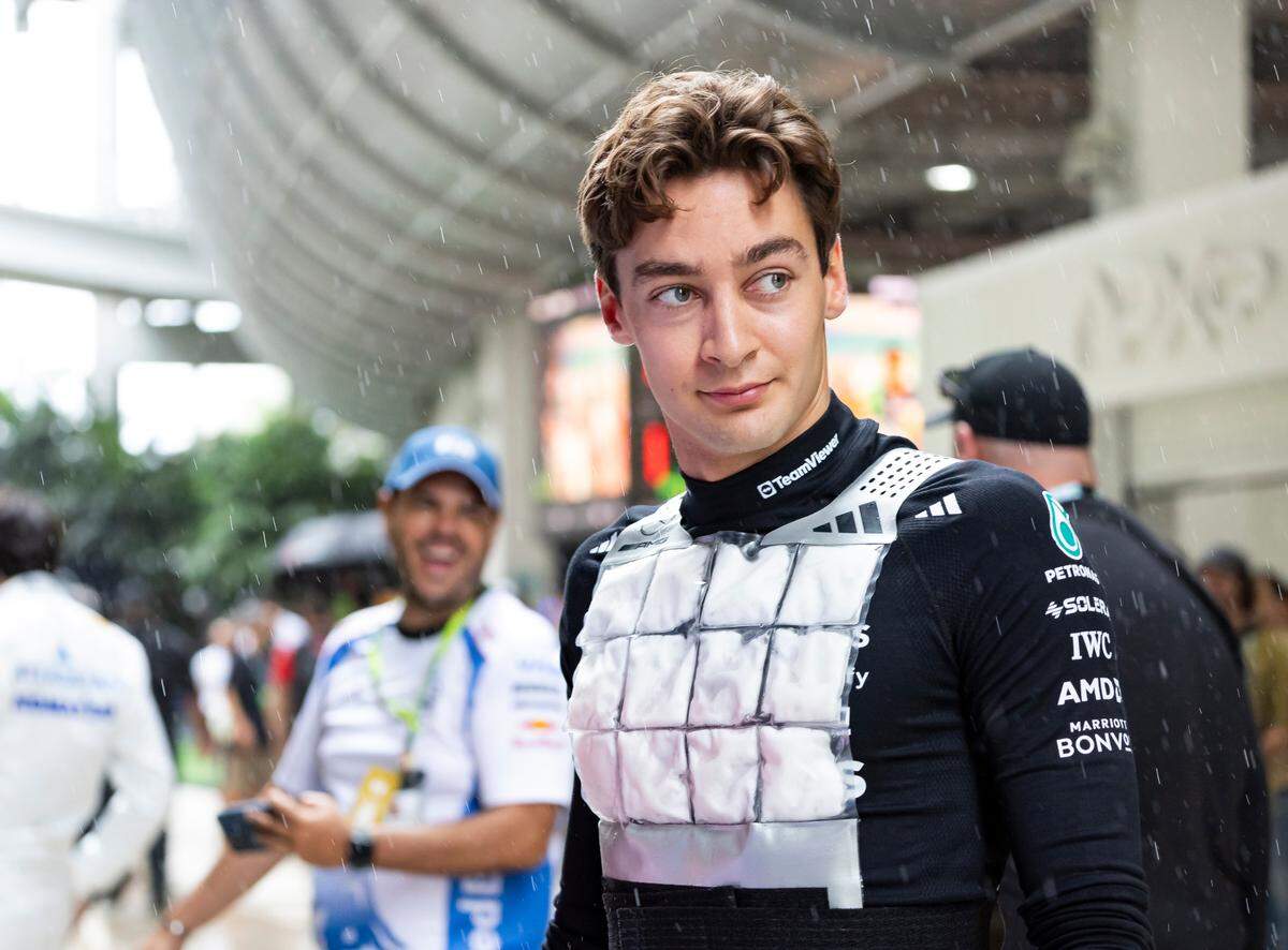 Mercedes driver George Russell of Britain walks toward his garage before the start of a Sprint race on the second day of the Formula One Miami Grand Prix at the Miami International Autodrome on Saturday, May 3, 2025, in Miami Gardens, Fla.