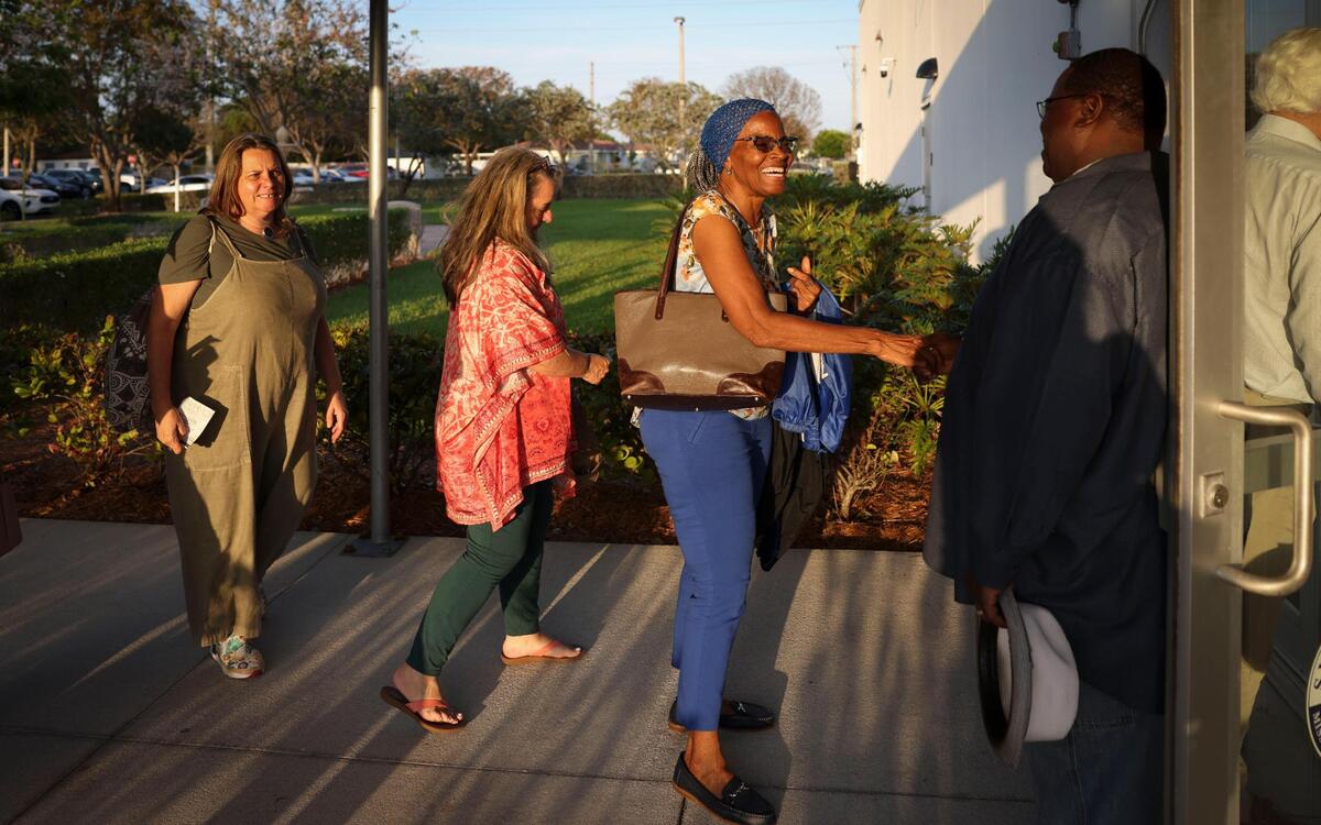 Mark Beckford, right, a member of Sweet Home Missionary Baptist Church, greets parishioners from Coral Gables Congregational UCC before the PACT Nehemiah Action Assembly on Monday, April 7, 2025, at Sweet Home Missionary Baptist Church in Cutler Bay, Fla.