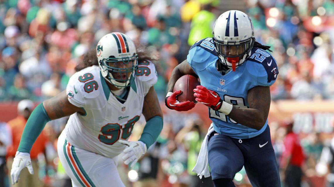 Miami Dolphins’ Paul Soliai chases Tennessee Titans’ Chris Johnson in the first quarter at Sun Life Stadium in Miami Gardens, Florida, November 11, 2012.