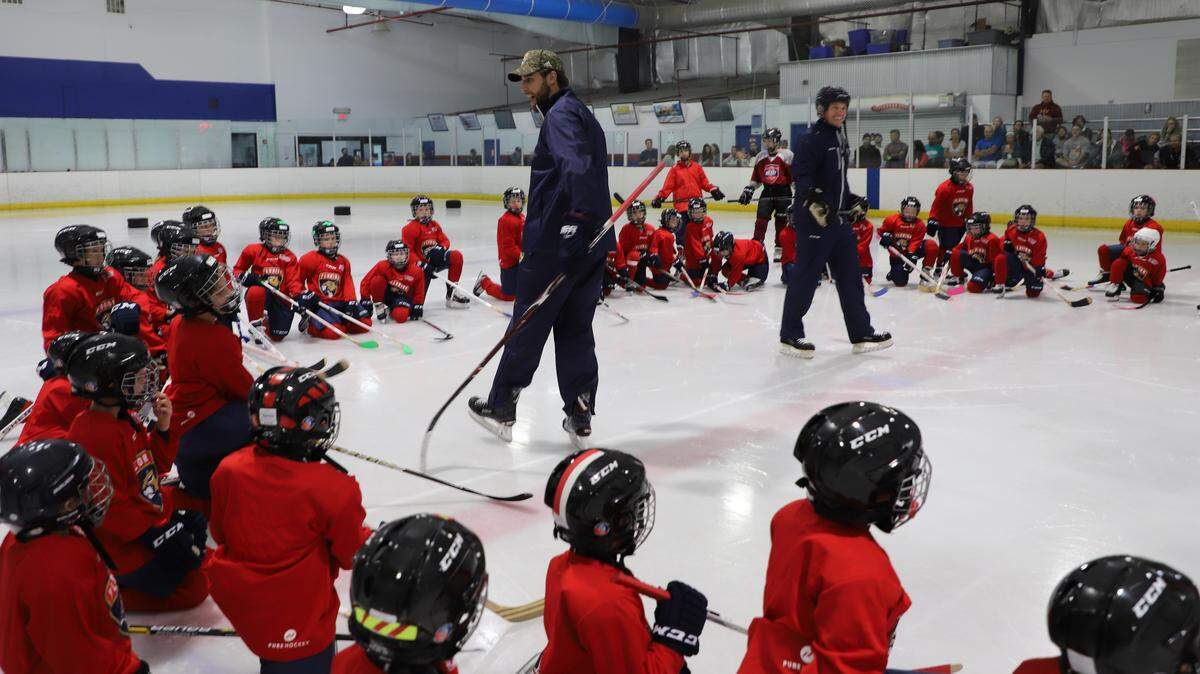 Florida Panthers defenseman Aaron Ekblad, center, speaks to a group of about 50 kids during a Learn to Play session at Palm Beach Skate Zone on Sunday Aug. 12.
