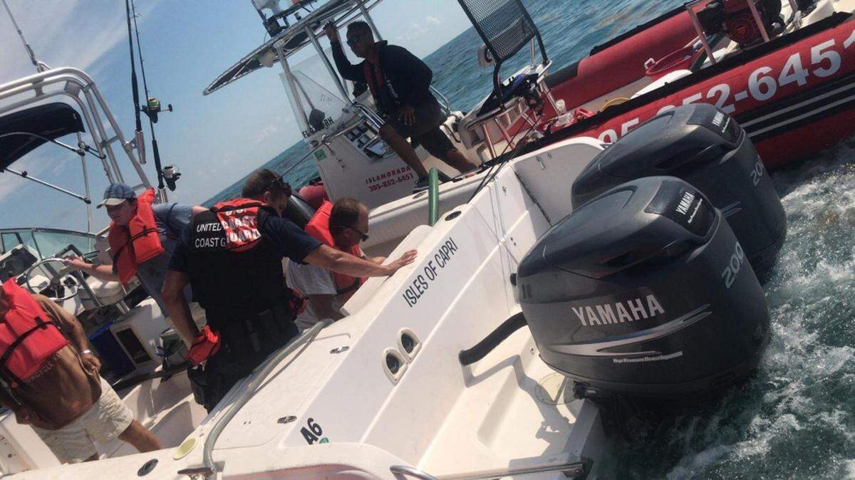 Three men were saved from their sinking boat by the U.S. Coast Guard about nine miles southeast of Tavernier Saturday.