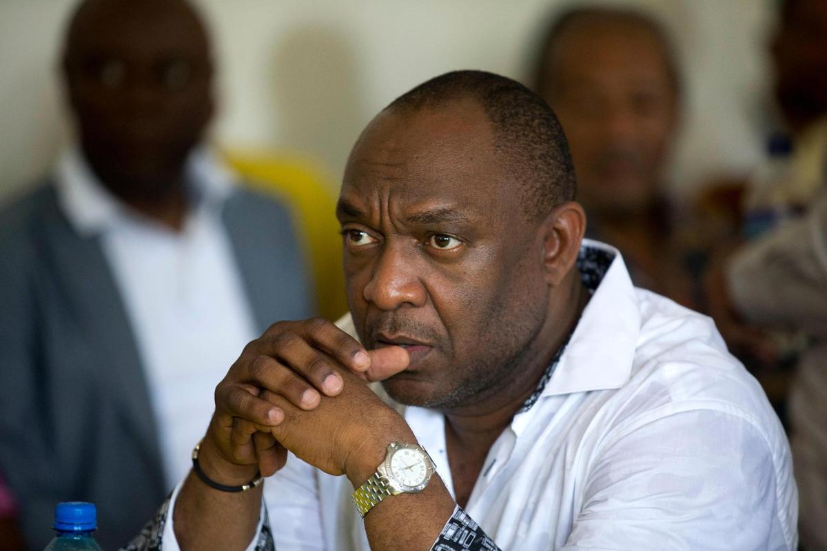 In this file photo, then-Sen. Youri Latortue sits as he waits to sign an agreement with leaders from the opposition to choose an interim president in place of President Jovenel Moïse before a protest to demand the resignation of President Jovenel Moïse , in Port-au-Prince, Haiti, Sunday, Nov. 10, 2019. Anger over corruption, inflation and scarcity of basic goods, including fuel, has led to more than a month of demonstrations that have paralyzed the country as protesters demand the resignation of Moïse.