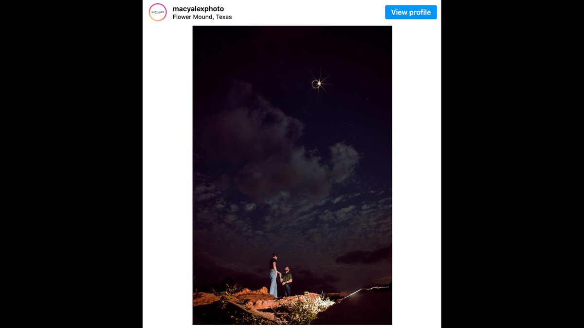 Photographer captures incredible engagement photo during the eclipse.