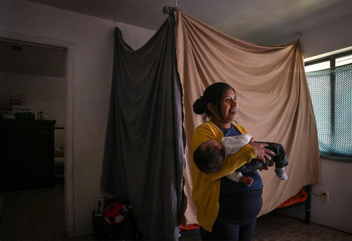 Marina C., 30, lives in a one-bedroom apartment in South Miami-Dade with her husband and four children. They struggle with high rent and low wages, leaving them with limited funds for essentials like furniture, a larger apartment, baby items, clothing, food and a computer for their children. Marina reflects on seeking a better life while caring for her two-month-old son, Anthony J., on Dec. 18, 2024.