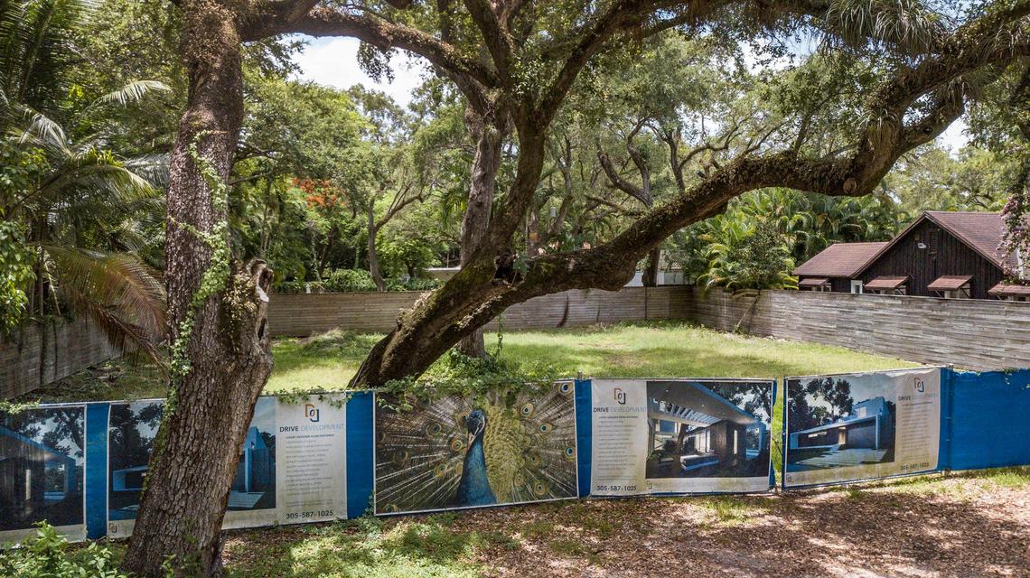 Signs of the times: Drive Development advertises a luxury designer home along a fence in the 2000 block of Secoffee Street in North Coconut Grove.
