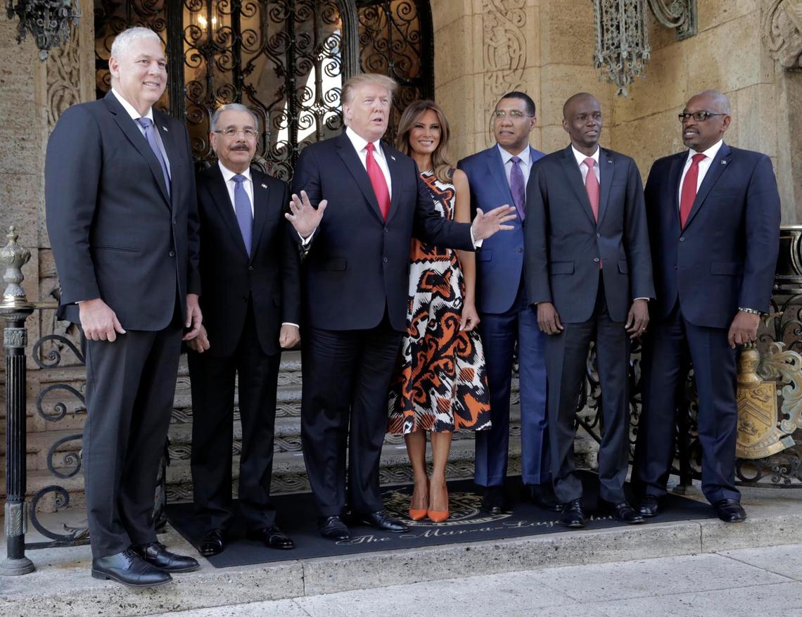 From left, Prime Minister of St. Lucia Allen Chastanet; President of the Dominican Republic, Danilo Medina; President Donald Trump; First Lady Melania Trump; Prime Minister of Jamaica Andrew Holness; Haitian President Jovenel Moise and Prime Minister of the Bahamas Hubert Minnis pose for a group picture before the meeting at Mar-A-Lago.