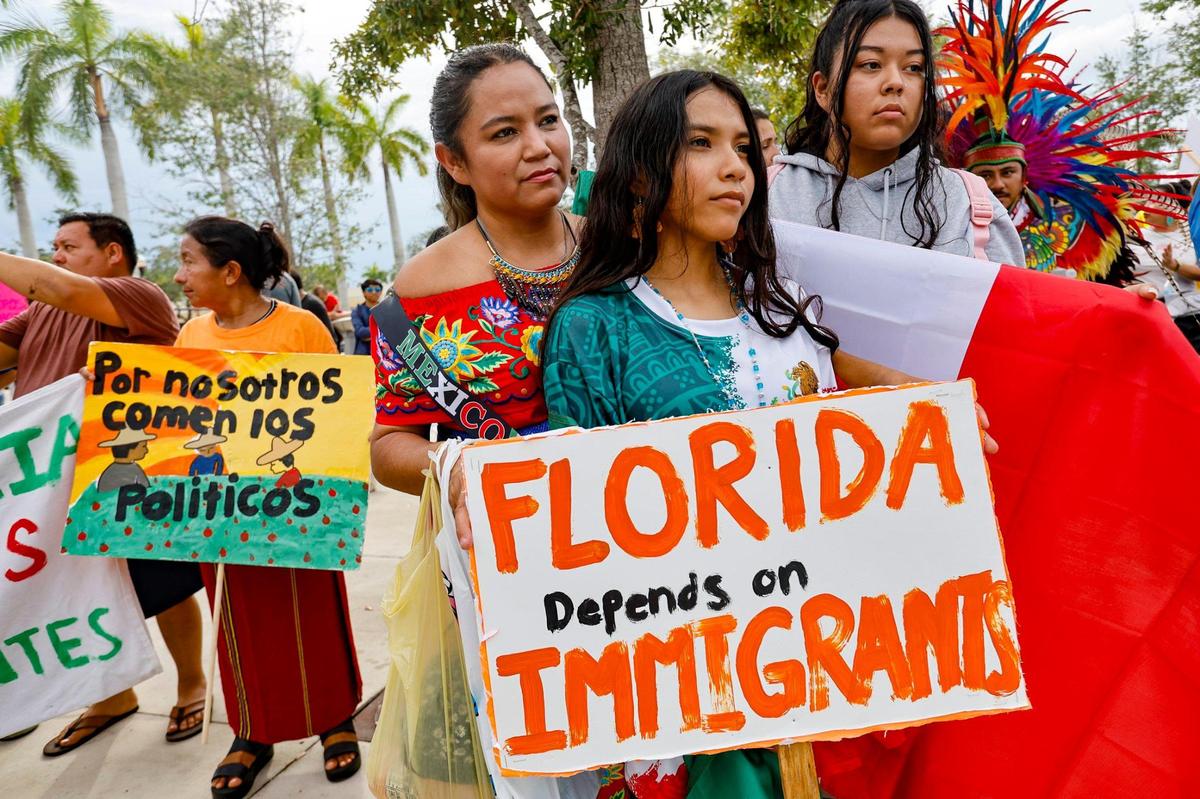 Gabriela Ibarra joins her daughters Kathy Camacho, 12, and Ashley Cruz, 18, as they listen to speakers at the “Freedom For All” rally against the bills passed by the Florida Legislature and signed into law by Gov. Ron DeSantis while protesting in Homestead, Florida on Saturday, July 1, 2023.