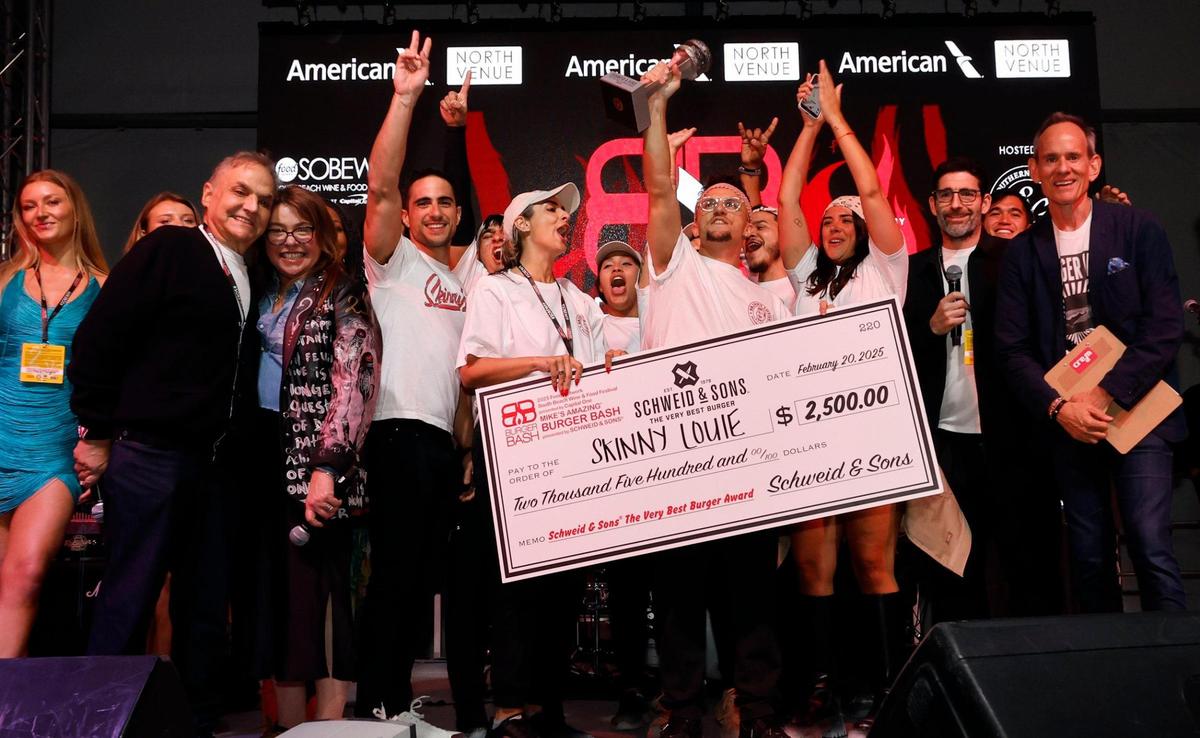 Gonzalo Rubino, owner of Skinny Louie, holds up the trophy for The Very Best Burger Award at the 2025 Burger Bash at the South Beach Wine & Food Festival in Miami Beach on Thursday, February 20, 2025.