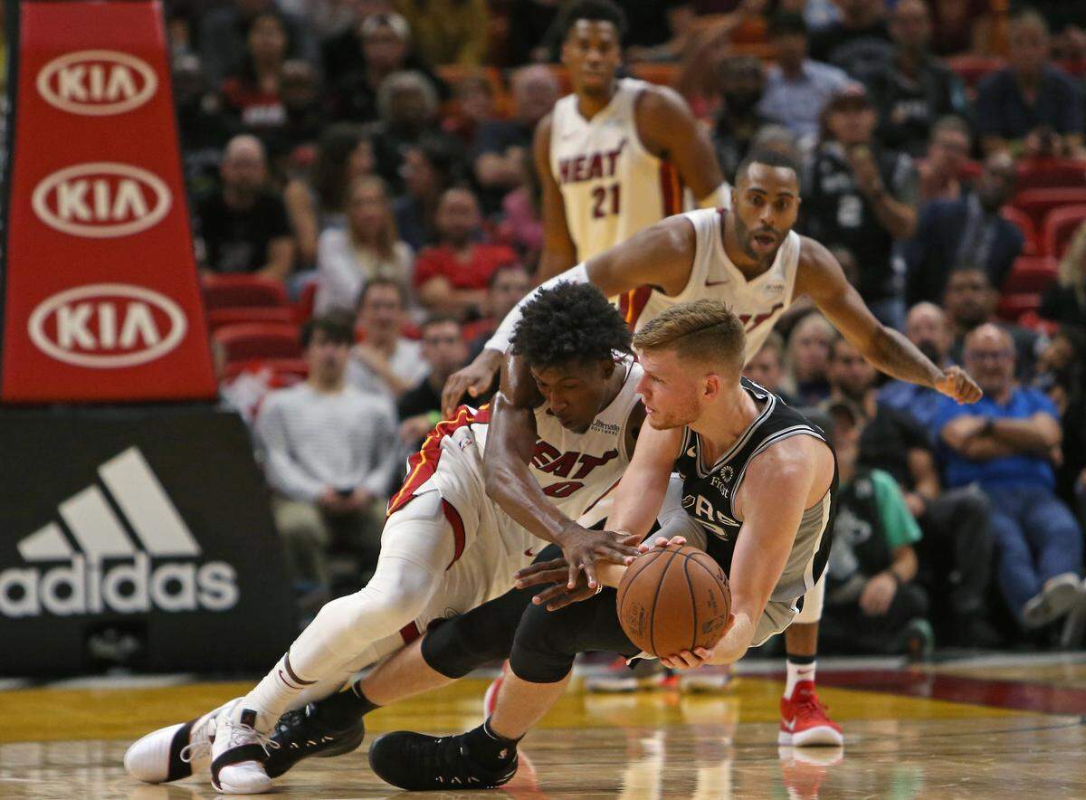 Miami Heat guard Josh Richardson battle for a lose ball against San Antonio Spurs forward Davis Bertans in the fourth quarter of an NBA basketball game at AmericanAirlines Arena on Wednesday, November 7, 2018 in Miami.