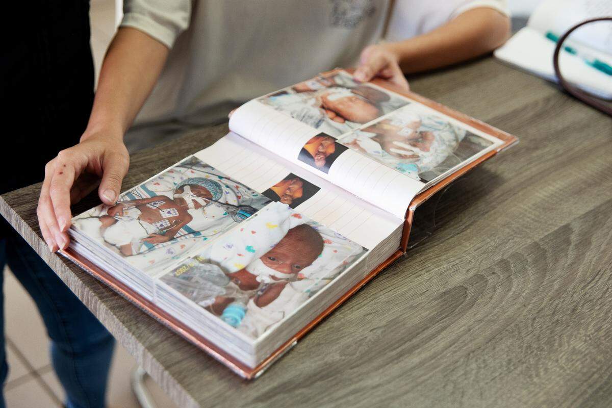 Yordanka Fernandez pages through a photo album of her son Nicholas Katrib’s time in the neonatal intensive care unit almost 18 years ago.
