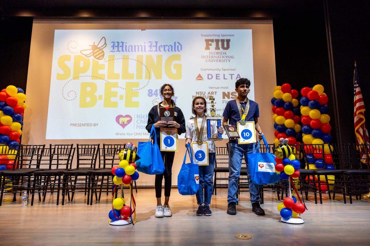 First Place winner Jasmine Perez from Bayview Elementary, center, second place winner Anvita Narasimhan from American Heritage School, left, and third place winner Stefano Carpio from Nativity Catholic School, right, react own stage after the Miami Herald Broward County Spelling Bee at NSU Art Museum in Fort Lauderdale, Florida on Thursday, March 7, 2024.