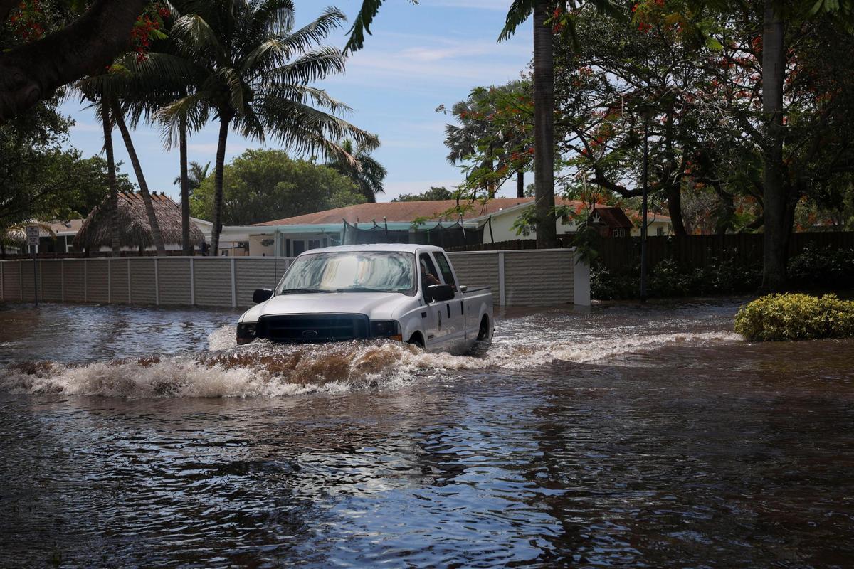 A truck turns onto Southwest 196th Street on Tuesday, June 7, 2022, in Cutler Bay following the weekend storms. Residents say the streets have been flooded for days.