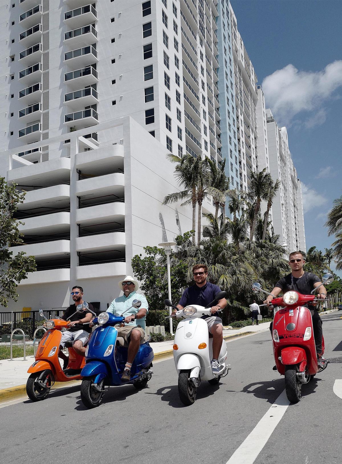 ( Left to right) Gil Nahmani, Jason Chute, Anthony V. Melvin and Michael Belica ride scooters in Miami Beach on Friday, May 4, 2018.