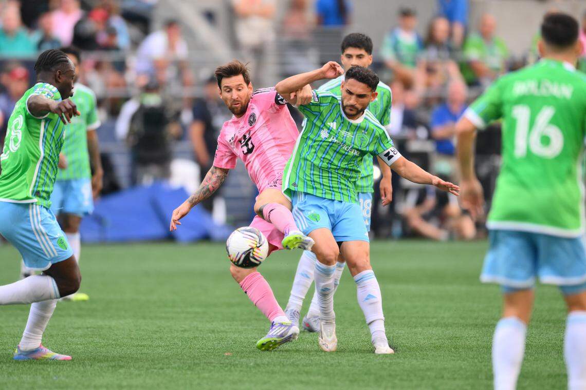 Aug 31, 2025; Seattle, Washington, USA; Inter Miami CF forward Lionel Messi (10) and Seattle Sounders FC midfielder Cristian Roldan (7) play the ball during the first half at Lumen Field. Mandatory Credit: Steven Bisig-Imagn Images