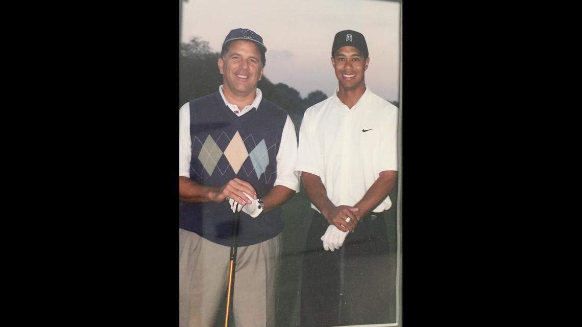 Andrew Kowalcykz, left, with pro golfer Tiger Woods during a pro-am tournament in 2002.
