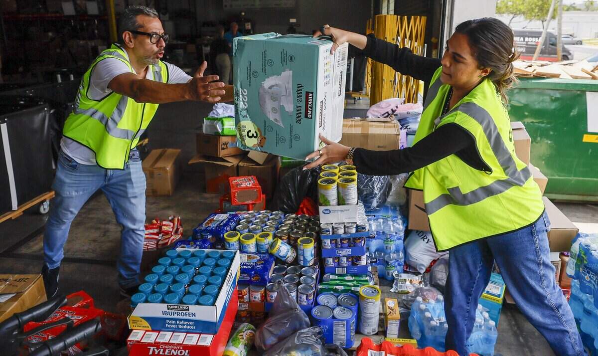 Global Empowerment Mission volunteers Carlos Bermudez and Ariana Guerrero move donated supplies for communities devastated by the recent powerful earthquakes in Venezuela.