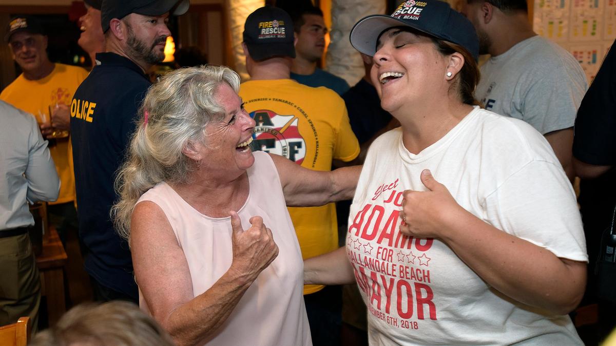 Joy Adams, left, laughs with Anabelle Lima-Taub while waiting for results to be posted on Tuesday, Nov. 6, 2018, at Flashback Diner. Adams was elected mayor of Hallandale Beach.