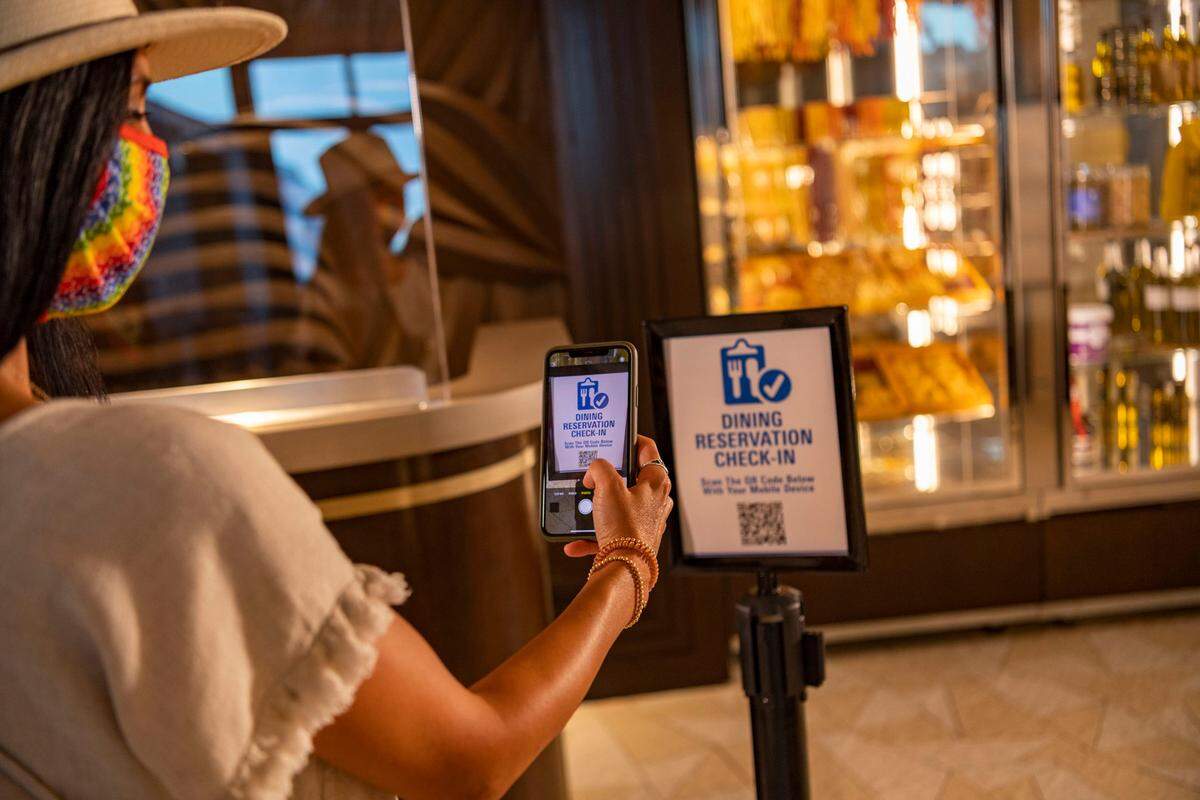 The My Disney Experience mobile app now offers a mobile check-in option for select table-service restaurants at Walt Disney World Resort in Lake Buena Vista, Fla. Guests receive a push notification on their mobile device when their table is ready; they can also begin the check-in process by scanning a QR code located in the restaurant’s lobby. (Matt Stroshane, photographer)