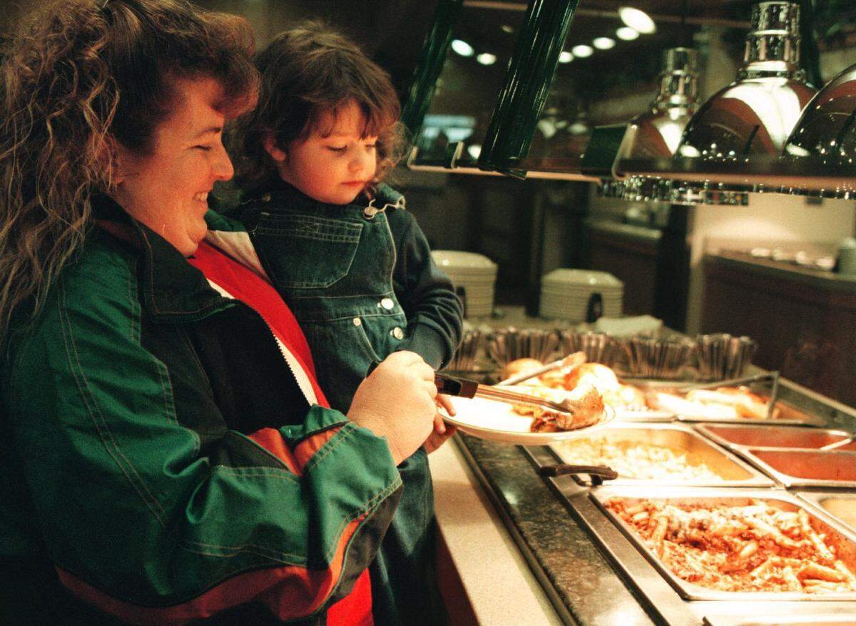 In 2001 at the Hometown Buffet in Davie, Sherry Dempsey of Fort Lauderdale helps 3-year-old daughter Roberta Dempsey.