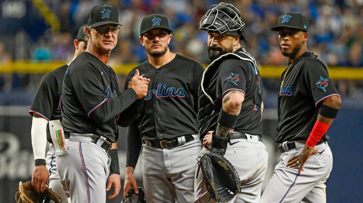Miami Marlins manager Don Mattingly, from left to right, talks on the mound with Miguel Rojas, Sandy Leon and Lewin Diaz during a baseball game against the Tampa Bay Rays Saturday, Sept. 25, 2021, in St. Petersburg, Fla. (AP Photo/Steve Nesius)