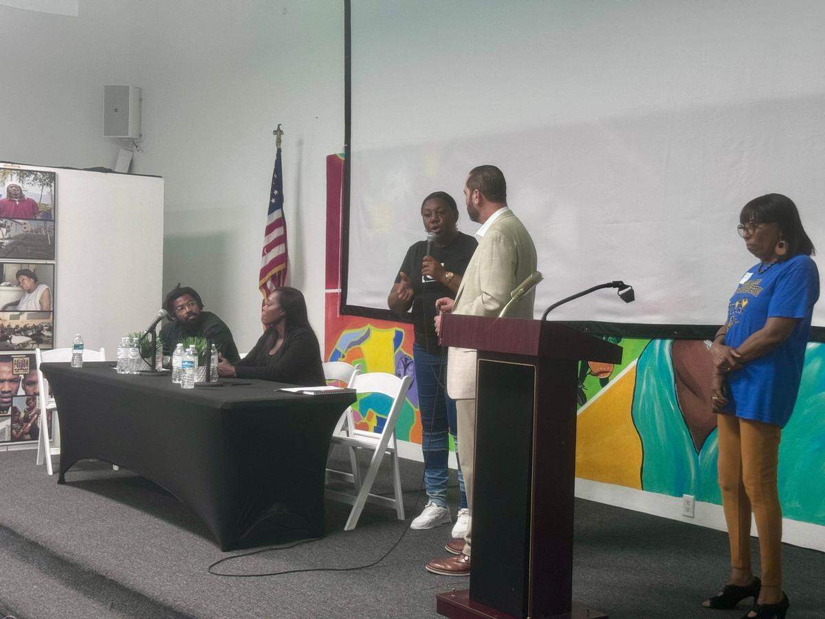 (From left to right) Phil Agnew, Samantha Quarterman, Trenise Bryant, Alex Ballina and Anna Williams on stage at the Liberty Square town hall. More than 100 Liberty Square residents and community advocates came out as tenants voiced their concerns about the property’s mold and structural damages.