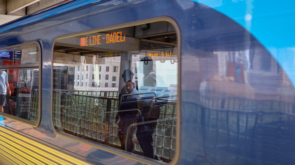 Reflections of commuters waiting to board the Orange Line toward Dadeland are cast on the train’s window as a passenger looks outward on Wednesday, July 24, 2024, in downtown Miami.