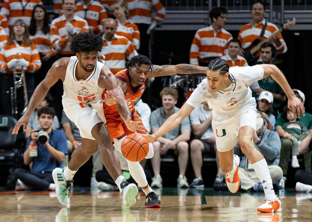 Miami Hurricanes forward Norchad Omier (15) and Virginia Tech Hokies guard MJ Collins (2) fight for possession of the ball during the first half of their NCAA basketball game at the Watsco Center on Saturday, Feb. 3, 2024, in Coral Gables, Fla.