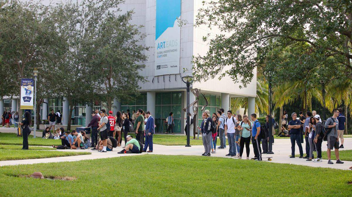 Students gather near the Blue Garage at FIU's Modesto Maidique Campus on Thursday, Nov. 2, 2017. According to campus safety and security data from the U.S. Department of Education, FIU had a rate of 0.15 incidents of rape per 1,000 students in 2016. That's the lowest rate compared to UM (.24) and other large state public universities such as the University of Central Florida (0.27), and University of Florida and Florida State University (both at .44).
