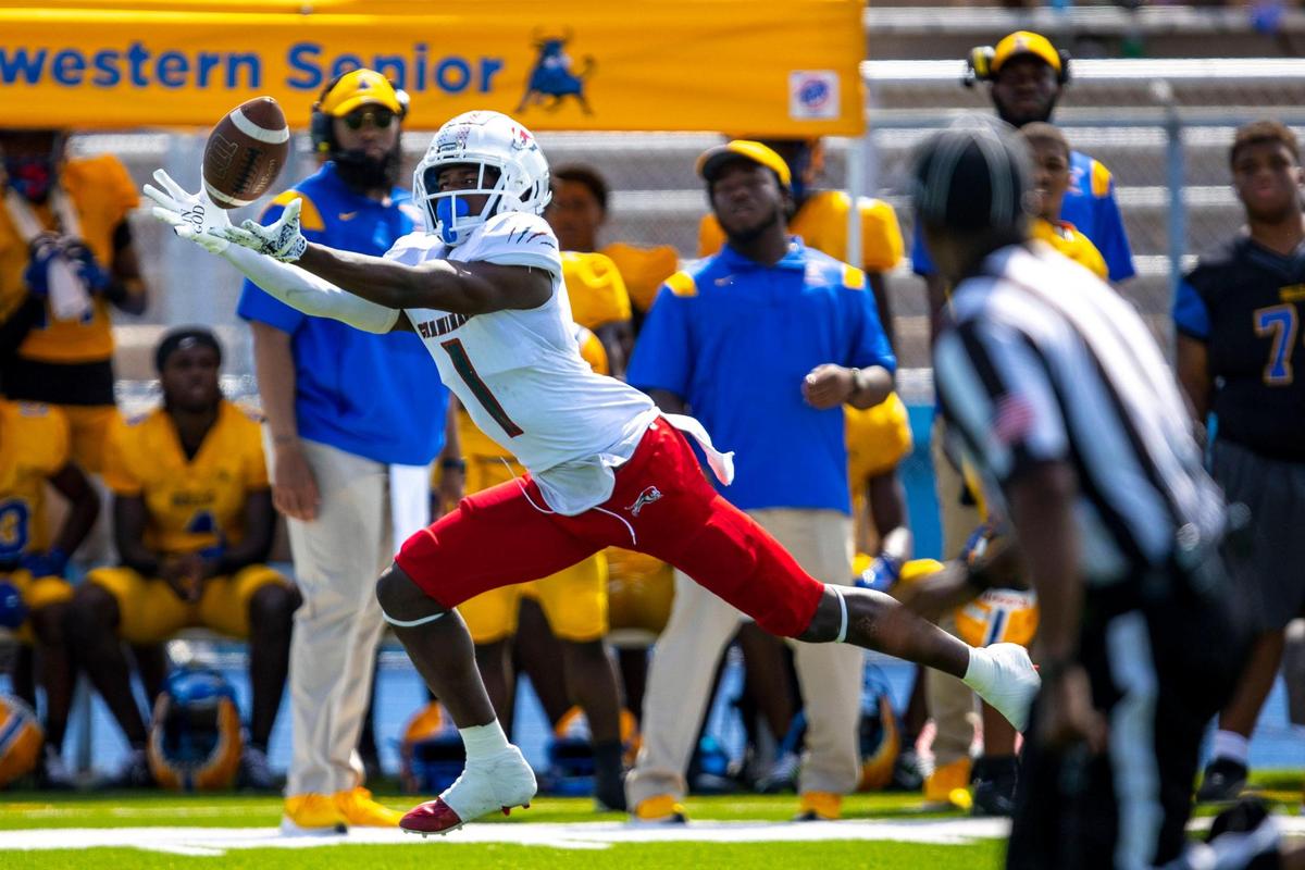 Chaminade-Madonna athlete Joshisa Trader (1) stretches for the catch during the first quarter of a high school football game against Miami Northwestern at Nathaniel Traz Powell Stadium in Westview, Florida, on Saturday, September 10, 2022.