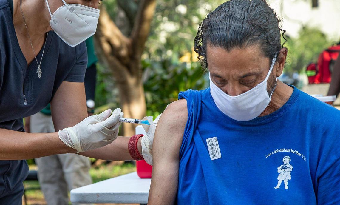Nurse Niurka Pérez gives a shot of the (J&J/Janssen) COVID-19 vaccine to Khriss Montenegro, a homeless man living in downtown Miami as part of the Miami-Dade County Homeless Trust and the Florida Division of Emergency Management’s vaccination tours throughout to ensure people experiencing homelessness have easy access to the vaccine, on May 21, 2021.