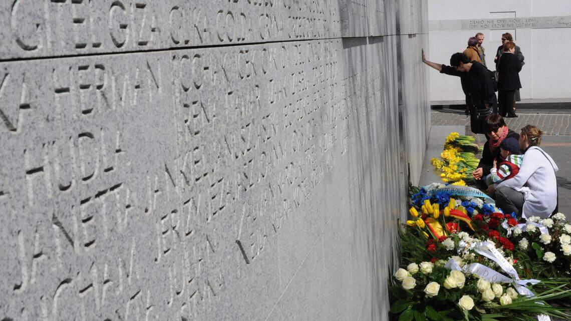 People stop at the Umschlagplatz monument during a ceremony commemorating the 68th anniversary of the beginning of the uprising in the Warsaw Ghetto during World War II, in Warsaw, Poland, Tuesday, April 19, 2011. Warsaw Ghetto Jews were deported from Umschlagplatz to German Nazi death camps.