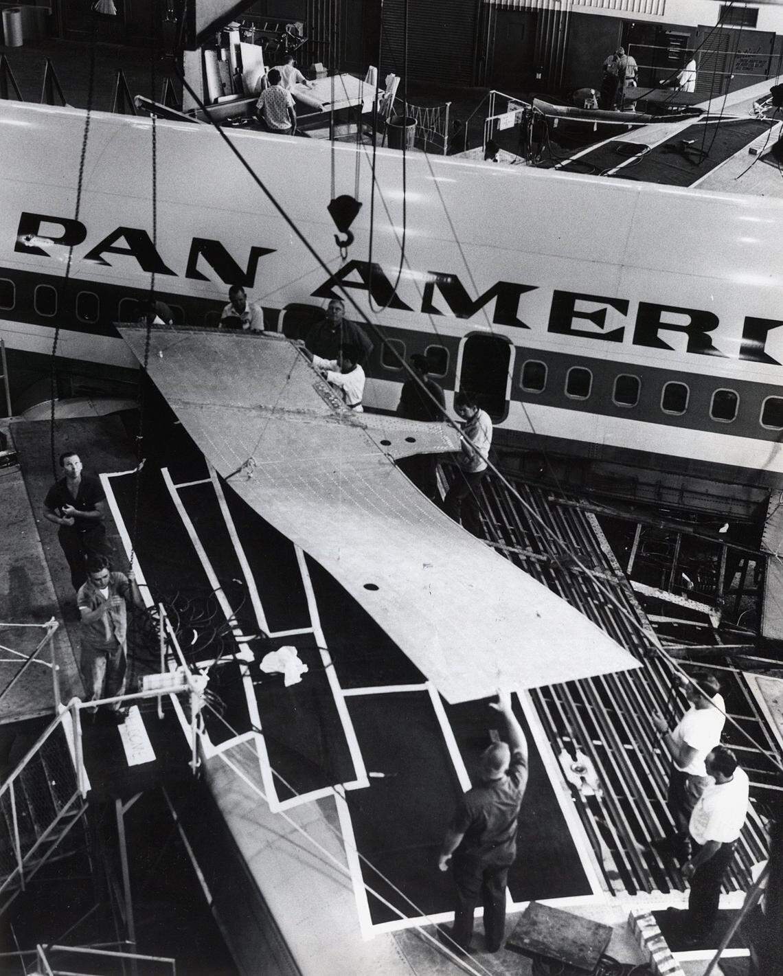 In 1968, Pan Am workers lower a wing panel into place in Miami.