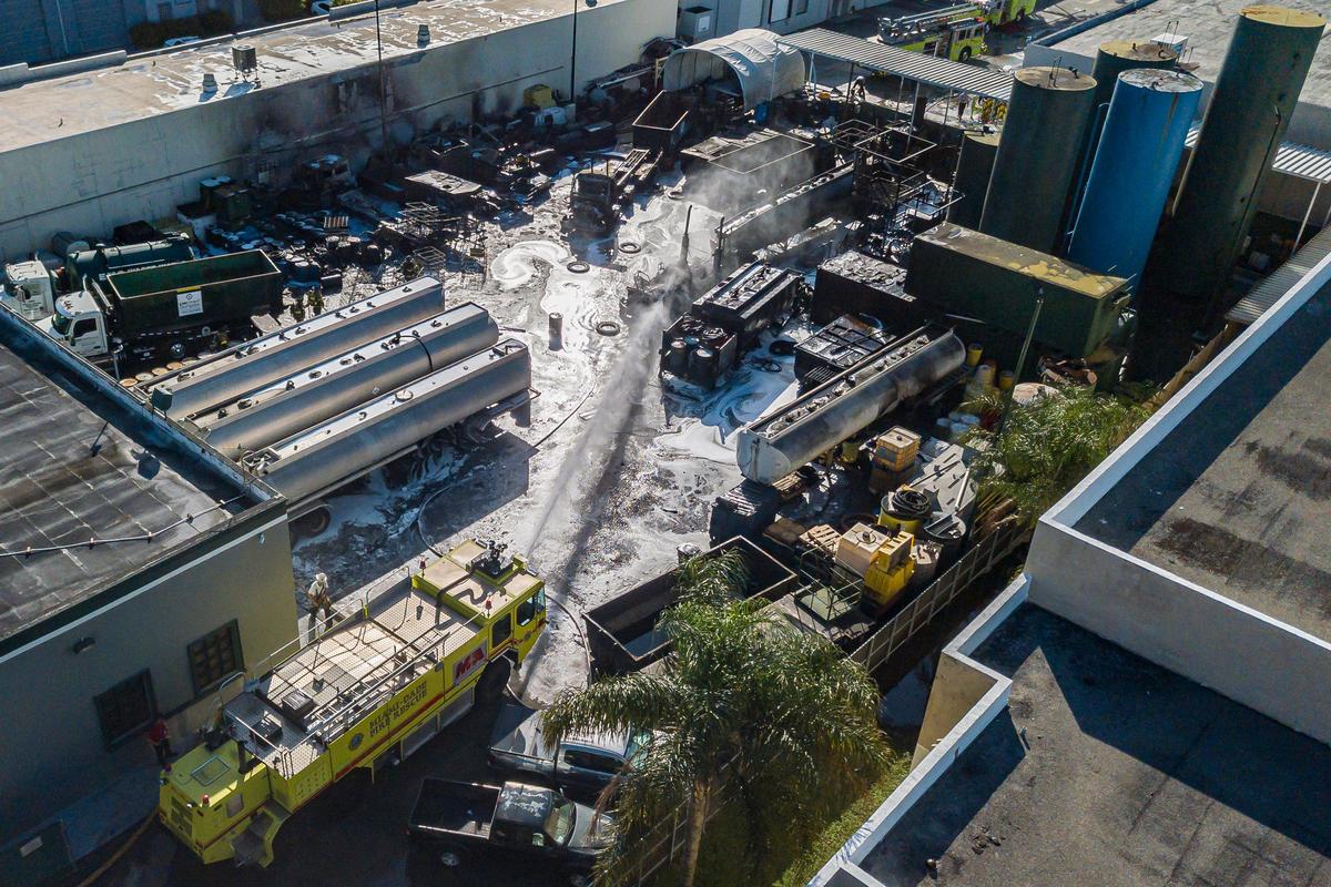 Aerial view shows firefighters extinguishing a fire that broke out at EMC Oil Corp., a used oil recycling refinery, near Doral, Florida on Wednesday, January 15, 2020. At least 34 units were sent to combat the fire at the area and the cause of the fire is under investigation.