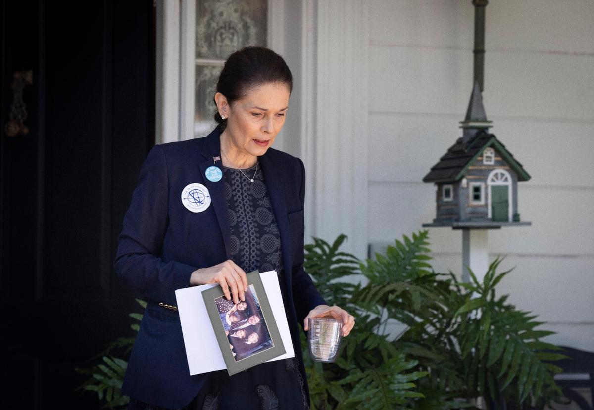 Victoria Cummock, widow of passenger John B. Cummock, walks out of her home before a press conference on Monday, April 25, 2022, in Miami.