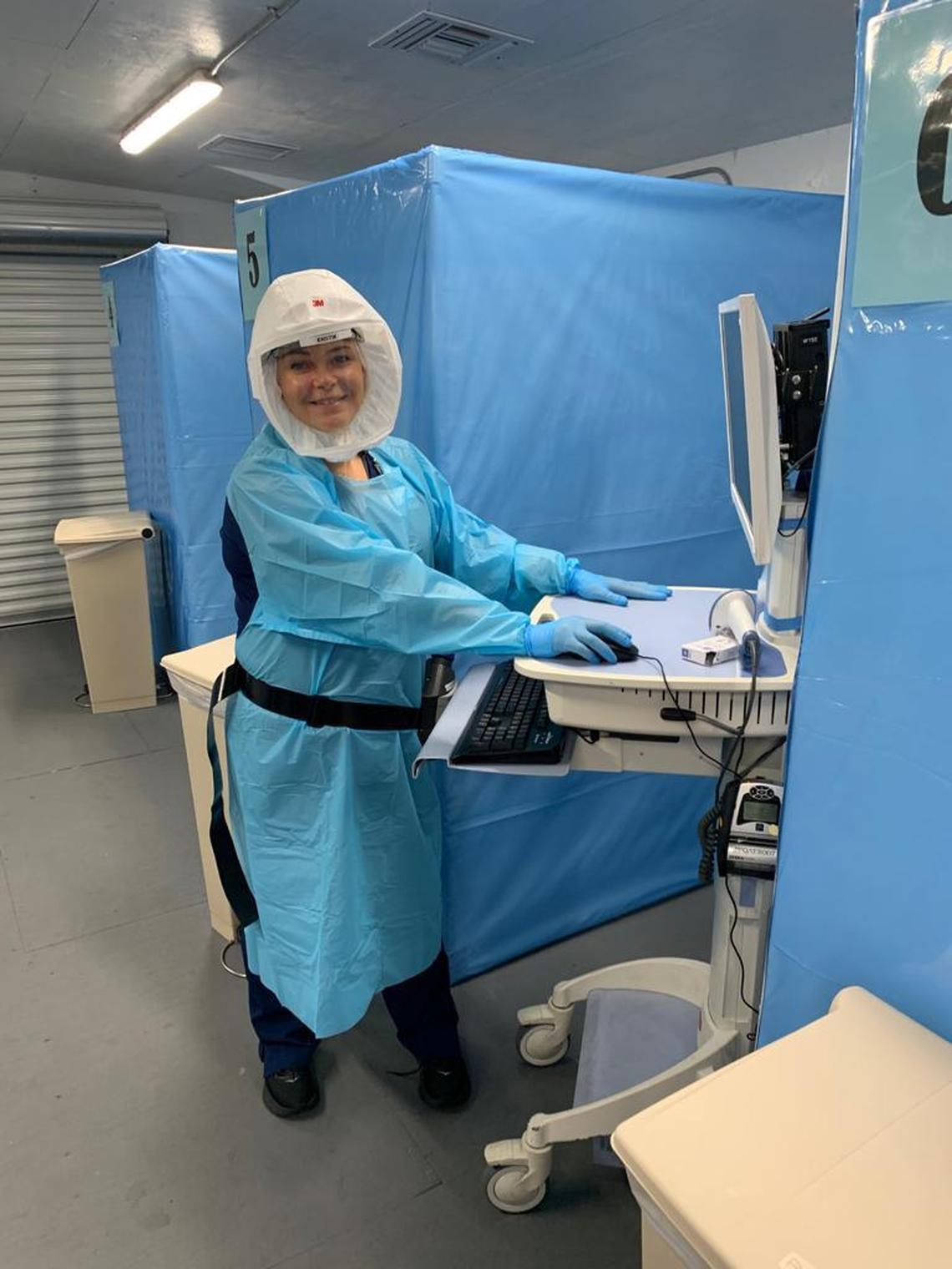  Nurse Kristin Percival Schmalz&nbsp;works at a Memorial Hospital Pembroke Emergency Room Monoclonal Antibody Infusion treatment area in preparation for a COVID-19 patient’s arrival.