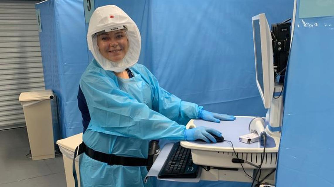  Nurse Kristin Percival Schmalz works at a Memorial Hospital Pembroke Emergency Room Monoclonal Antibody Infusion treatment area in preparation for a COVID-19 patient’s arrival.