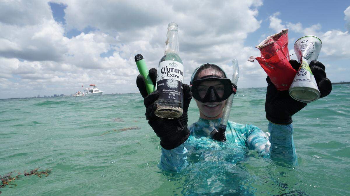 Maddie Kaufman, Debris Free Ocean’s program director, holds up trash she recovered by the Nixon Beach sandbar off Key Biscayne. Working with the Aspen Institute, the city of Miami Beach and Deco Drivers, Debris Free Ocean removed 89 pounds of debris.