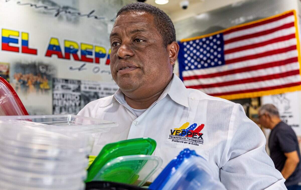 José Antonio Colina, president of Venezuelans Persecuted for Political Reasons in Exile, carries earthquake relief supplies before a news conference urging President Trump to grant Deferred Enforced Departure status to protect Venezuelans from deportation following Wednesday’s earthquakes near Caracas, El Arepazo Restaurant in Doral, Fla., on Friday, June 26, 2026.