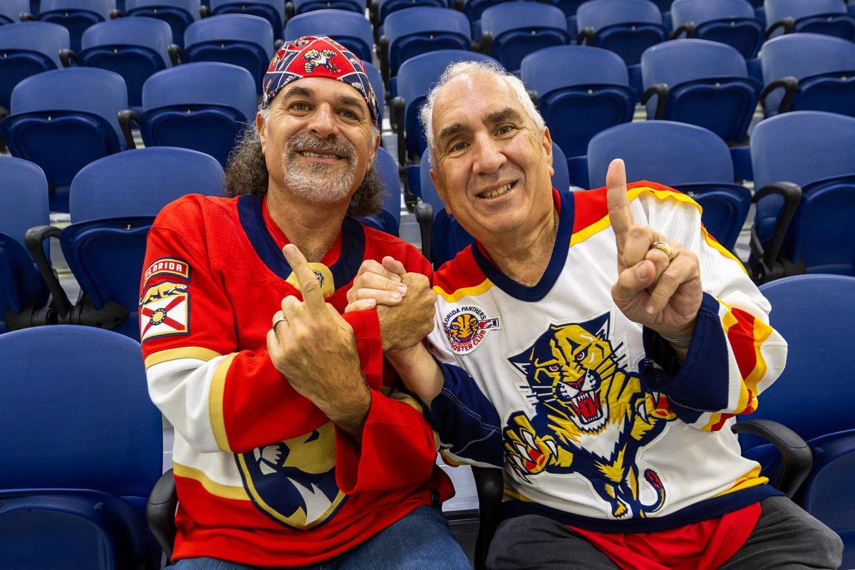 Carl Jkanas, The Cat Fan, left, and David Bierman, Florida Panthers Charter Season Ticket Holder, right, react at Baptist Health IcePlex on Friday, June 14, 2024, in Fort Lauderdale, Fla.