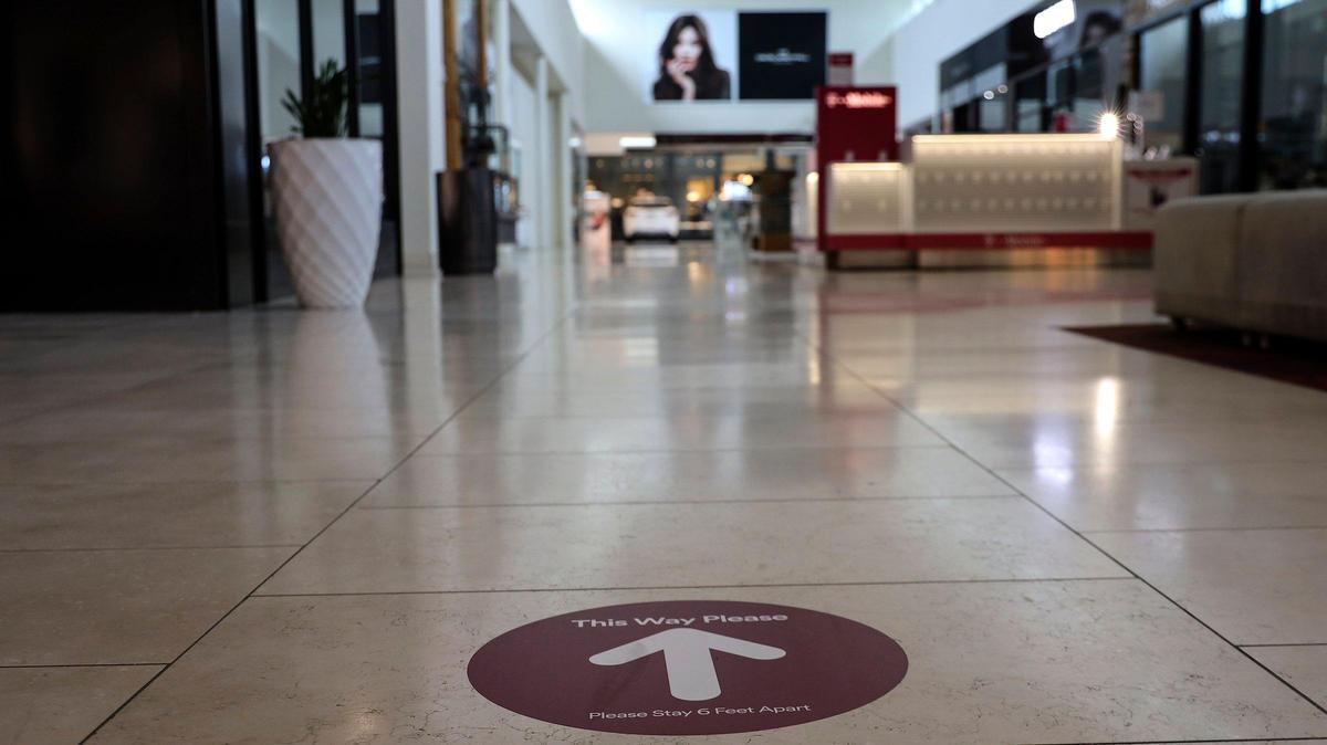 Directional signs are placed on the floor as a reminder of the direction for foot traffic as Dadeland Mall reopened with its comprehensive COVID-19 Exposure Control Policy on Monday, May 18, 2020.